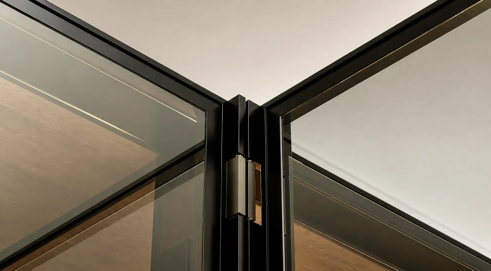 Close-up of a slim metal frame joining glass cabinet panels
