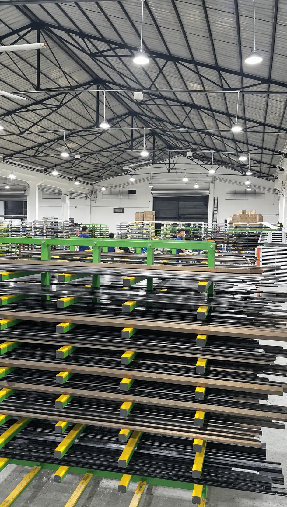 Metal frames organized on racks across the manufacturing workshop